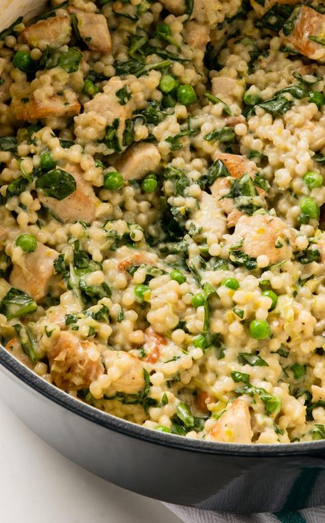 Couscous Risotto with Chicken and Spinach: We add spinach, Parmesan, peas, and cream to make this an ultimate comfort dinner. Couscous Risotto With Chicken And Spinach, Chicken Pearl Couscous, Spinach Parmesan Risotto, Chicken And Pearl Couscous, Greek Spinach And Rice – Spanakorizo, Comfort Dinner, America's Test Kitchen Recipes, Heirloom Recipes, Creamed Spinach