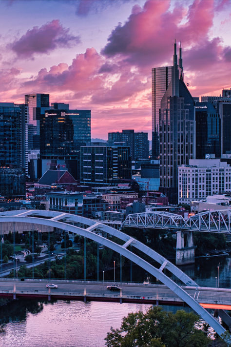 Skyline of Nashville shot from across the river as the sun sets and the sky in pink and full of clouds. Nashville Tennessee Aesthetic, Nashville Aesthetic, Tennessee Aesthetic, Nashville City, Thanksgiving 2024, Music City Nashville, Nashville Music, Luxury Collection Hotels, Driver Era