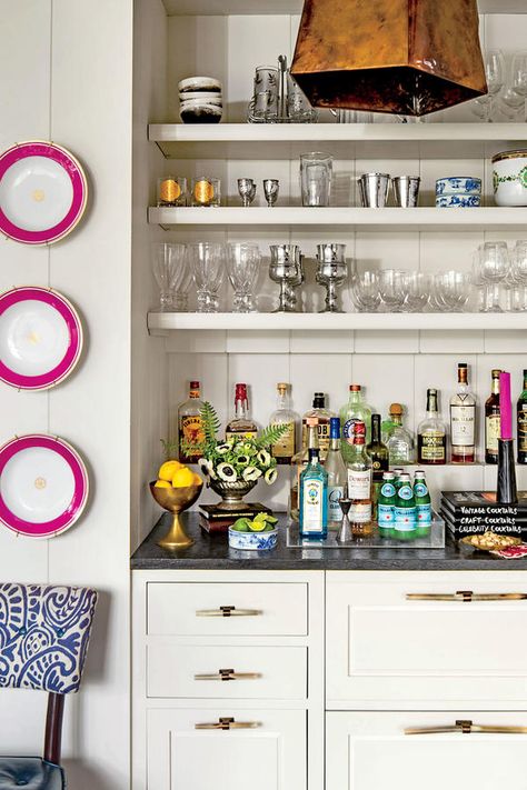 The Built-In Bar: Give It an Accent - 13 Achievable Ideas Inspired by a 1926 Tudor - Southernliving. The three pink-rimmed plates on the wall belonged to a previous owner of the house. Barrie accented them with matching pink candles from Blackhawk Hardware in Charlotte. Slate Interior, Bandeja Bar, Butler’s Pantry, Home Bar Design, Built In Bar, North Carolina Homes, Bar Styling, Wet Bar, Southern Living