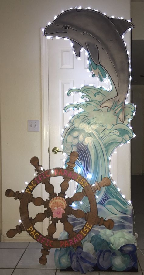 PACIFIC PARADISE  Dolphins cutout with lights, ship wheel made out of foam core paint,Cricut letters.  Photo booth Magalie Sarnataro’s props Ocean Props, Scuba Photo Booth, Ocean Props Sea Theme, Dolphin Poster Board Projects, Boat Stage Prop, Sea Backdrop Ocean Themes, Dolphin Photos, Stage Props, Ocean Birthday Party