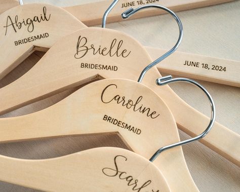 Custom Engraved Bridesmaid Hangers Add a personal touch to your big day with our custom engraved wooden hangers! 🎀 These hangers are perfect for displaying your wedding dress, bridesmaid dresses, or as a thoughtful gift for your bridal party. - 🌟 Size Options:   - Bridal Hangers: 17" wide   - Kids Hangers: 13 3/4" wide (ideal for sizes 3T to 12 years) - 🎨 Color Choices: Available in elegant White or classic Natural wood. - ✨ Key Features:   - Laser-engraved for a permanent, high-quality finis Bridal Proposal, Wedding Dress Hangers, Name Hangers, Bridesmaid Hangers, Kids Hangers, Bridal Hangers, Wedding Dress Hanger, Dress Hanger, Wooden Hanger