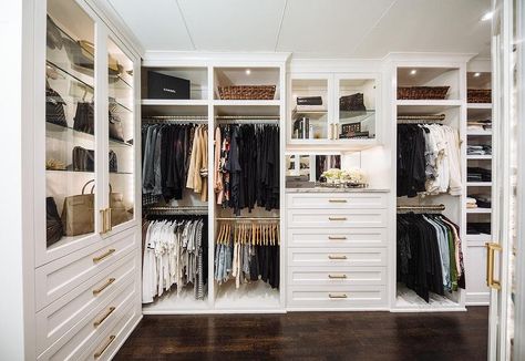 Large custom walk-in closet features white cabinets with brass pulls, marble countertops and glass front cabinet doors. Transitional Closet, A Walk In Closet, Master Closet Design, Dresser In Closet, Dressing Room Closet, Walking Closet, Dream Closet Design, Armoire Dressing, Walk In Closet Design