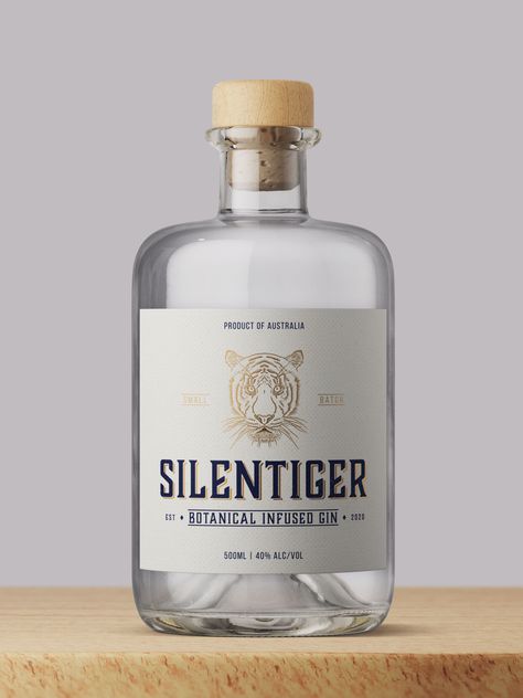 Our concept design for Silent Tiger Gin combines sophisticated branding, packaging and illustration. When approaching this project we wanted to emphasise the quality of small batch, botanical infused gin.   The label embellishments include metallic gold ink over a textured paper stock. #gin #label #design #embellishment #bottle #packaging Gin Label Design Branding, Liquor Bottle Label Design, Gin Bottle Label Design, Liquor Label Design, Gin Bottle Design, Gin Label Design, Gin Branding, Whisky Label, Gin Label