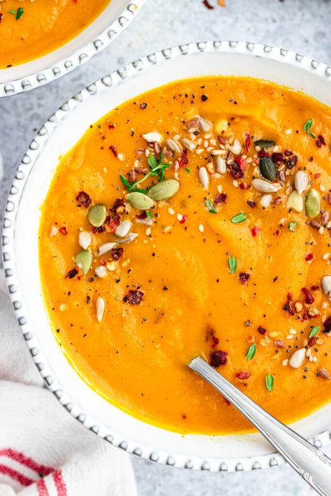 Carrot and sweet potato soup in a white bowl topped with seeds and spices. Carrot Sweet Potato Soup, Carrot And Sweet Potato Soup, Sweet Potato And Carrot Soup, Potato And Carrot Soup, Potato Carrot Soup, Carrot And Sweet Potato, Sweet Potato And Carrot, Sweet Potato Carrot Soup, Chilli Soup