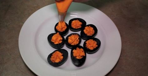 Make Deviled Eggs Like This for Halloween | TipHero Color Deviled Eggs, Colored Deviled Eggs Recipe, Dyed Deviled Eggs, Colored Deviled Eggs, Halloween Eggs, Pumpkin Deviled Eggs, Halloween Deviled Eggs, Halloween Party Appetizers, Fun Halloween Treats