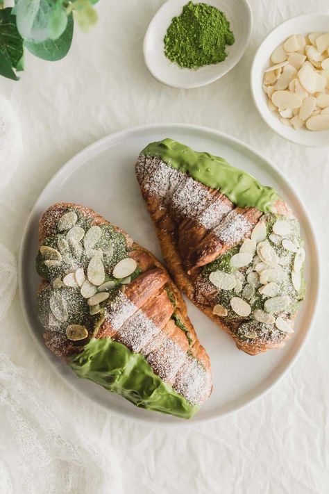 Two green tea almond croissants on a white plate. Croissant Aesthetic, Veg Crispy, Crossant Recipes, Matcha Almond, Almond Croissants, Matcha Mochi, Bake Sale Packaging, Matcha Cafe, Dinner Party Dishes