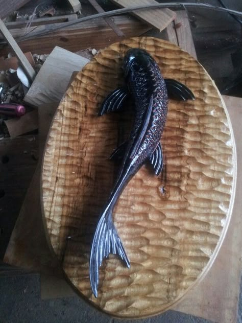 Black koi carved in mahogany and charred on a textured cypre  back. Koi Fish Wood Carving, Koi Sculpture, Fish Wood Carving, Cutlery Art, Wood Comb, Geometric Sculpture, Dremel Wood Carving, Wood Fish, Clay Wall Art