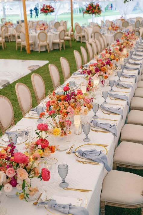 |NK Wedding Planning. Get in touch with us today.| Bay Preserve Wedding, outside wedding, tented wedding, floral centerpieces, pink, blue, orange, roses, gold, blue napkins, gold silverware, louis chair natural, ~Taken by Hunter Ryan Photo~ Vogue Wedding Tablescape, Wedding Lots Of Flowers, Pink And Orange Wedding Palette, Red Orange Pink Blue Wedding, Bright Summer Wedding Table Decor, Love In Full Bloom Wedding, Multi Color Flower Wedding, Colorful Wedding Linens, June Beach Wedding Colors