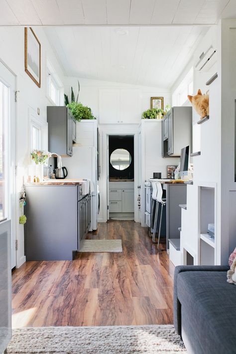 The main living area is bright and airy with the white shiplap walls, white ceiling, and medium tone flooring. Murrieta California, Tiny House Furniture, White Shiplap Wall, Small House Interior, Rustic Exterior, Best Tiny House, Tiny House Listings, Tiny House Kitchen, Modern Tiny House