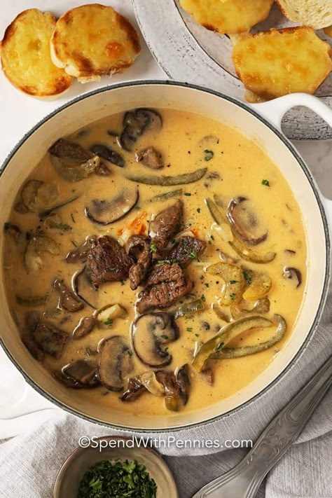 This Philly Cheesesteak Soup is a delicious twist on your favorite sandwich. A creamy and cheesy soup topped with cheese and served with a cheesy baguette! #spendwithpennies #phillycheesesteaksoup #soup #cheesy #delicious #cheesesteak Cheesy Baguette, Philly Cheesesteak Soup Recipe, Philly Cheesesteak Soup, Steak Soup Recipes, Cheesesteak Soup, Cheesy Soup, Peppers And Mushrooms, Steak Soup, Homemade Soup Recipe