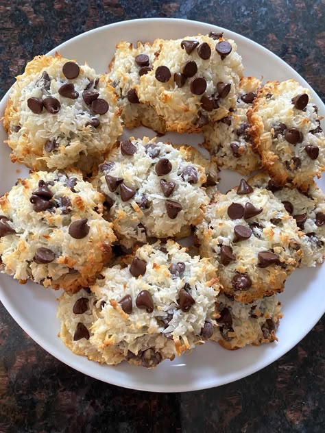 The delicious combination of coconut and chocolate makes these cookies a winner! If you like coconut, you'll love these Coconut Chocolate Chip Macaroons, made with just 4 ingredients. Coconut Macaroons With Chocolate Chips These easy cookies are perfect for those who love coconut. The sweet coconut flakes are so yummy with the rich chocolate chips. Soft and chewy, these macaroons will be a hit with everyone. And they're popular year-round! For winter, the coconut can be snow... just add some ... Chocolate Coconut Cookies 4 Ingredients, Chocolate And Coconut Recipes, Chocolate Kissed Coconut Macaroons, Oatmeal Coconut Chocolate Cookies, 2 Ingredient Coconut Macaroons, Coconut And Chocolate Cookies, Cookies With Coconut And Chocolate Chips, Macaroon Recipes Coconut, Coconut Chocolate Recipes