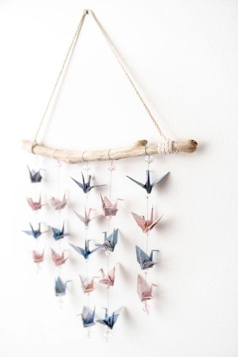 Origami cranes hang from driftwood #homedecorideas handmade #origamicrane #decor Paper Crane Crafts, Paper Crane Wall Art, Origami Display Ideas, Paper Crane Decoration, Hanging Origami Cranes, Origami Crane Hanging, Origami Crane Wall Art, Origami Crane Mobile Diy, Origami Crane Mobile