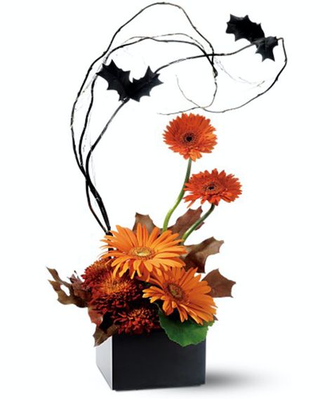 How do you turn the cheerful gerbera into a frightening flower? It's batty simple, really. Arrange one part creepy tricks with two parts beautiful treats, and watch the fun bloom. #ConklynsFlorist Halloween Arrangements, Halloween Flower Arrangements, Autumn Arrangements, Halloween Floral Arrangements, Halloween Centerpieces, Halloween Setup, Pumpkin Floral Arrangements, Moldes Halloween, Halloween Floral