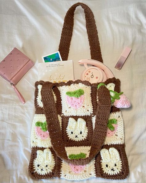 Creds to @sun_kissed_stitches on ig <3 Cutest granny square tote with miffy and strawberry squares. Comes with a strawberry charm. Cute miffy bag. Crochet bunny tote. Whimsical miffy design. Bunny-inspired tote. Unique crochet tote. Trendy bunny tote. Sustainable crochet tote. Eye-catching bunny design. Must-have miffy accessory. High-quality handmade tote bag. Shipping to republic of ireland only. Miffy Crochet Bag, Bunny Crochet Bag, Miffy Granny Square, Bunny Granny Square, Strawberry Squares, Miffy Bag, Miffy Crochet, Granny Square Tote, Tote Crochet