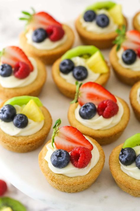 Take a classic sugar cookie to the next level with these fruit cheesecake sugar cookie cups! Chewy, moist cookies filled with a creamy cheesecake filling and topped with fresh fruit. Delicious! Sugar Cookie Fruit Cups, Cheesecake Sugar Cookie Cups, Sugar Cookie Fruit Tart, Moist Cookies, Life Love And Sugar, Fruit Sugar Cookies, Sugar Cookie Cups, Fruit Cheesecake, Strawberry Cream Pies