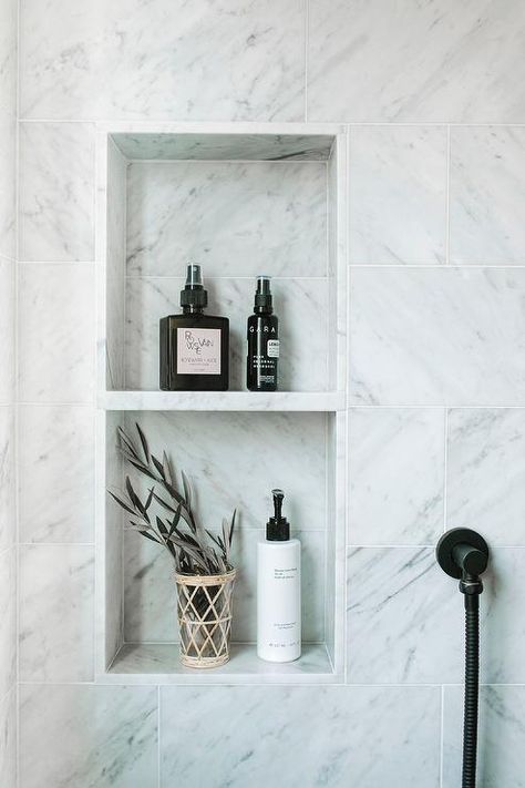 A marble shower niche fitted with tow shelves is framed by staggered honed marble wall tiles. Subway Tile Shower Niche, Marble Niche, تصميم دورة مياه, White Subway Tile Shower, Tile Shower Niche, Marble Shower Tile, Bathroom Niche, Subway Tile Showers, Marble Shelf