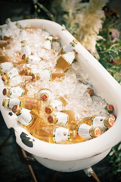 If you ask us, there are two kinds of weddings: ones that follow trends and ones that set them. So when we see a ceremony devoid of all the cliché Pinterest ideas — we get pretty (okay, very!) excited.  Enter San Francisco couple Jacy Ceccarelli and John Keddie, who really reinvented the wheel Bathtub Wedding Drinks, Beer Bucket Wedding, Beer Bath Wedding, Wedding Drink Trough, Edgy Backyard Wedding, Vintage Bar Wedding, Bathtub Cooler, Wedding Cooler Ideas, Wedding Happy Hour Ideas