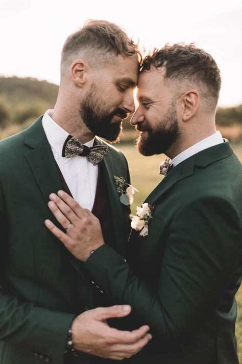 Two grooms in matching dark forest green suits with floral patterned bow ties and white rose buttonholes as they rest theri foreheads against each other Forest Green Suits, Syon Park Wedding, Gay Wedding Photography, Green Suits, Gay Wedding Photos, Gay Wedding Cakes, Two Grooms, Forest Theme Wedding, Queer Weddings