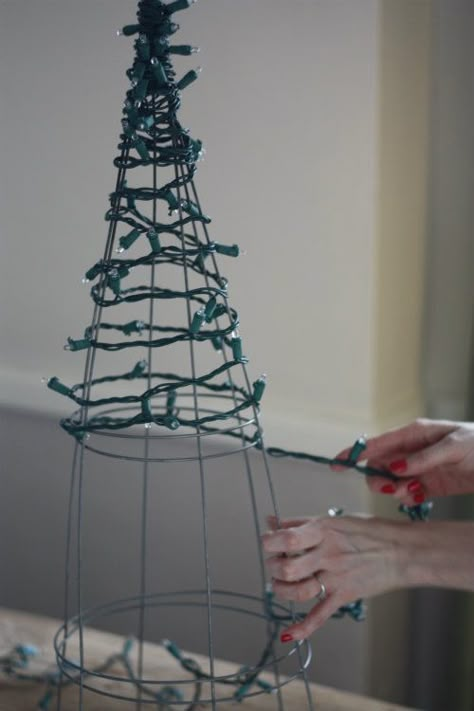 17 Apart: DIY: Tomato Cage Christmas Tree Lights Diy Tomato Cage Christmas Tree, Diy Tomato Cage, Holiday Decor Hacks, Tomato Cage Christmas, Tomato Cage Christmas Tree, Diy Christmas Lights, Outdoor Christmas Decor, Candyland Christmas, Christmas Tree Lights