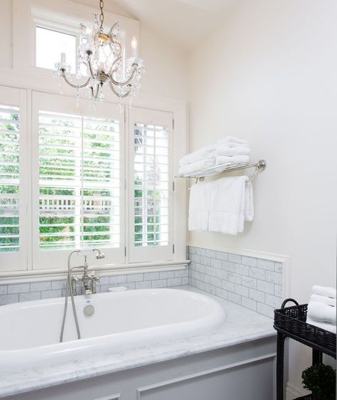 Chandelier over bathtub in bright white bathroom Farmhouse Chandelier Bathroom, Small Bathroom Chandelier, Window Bathtub, Bathroom Chandelier Over Tub, Bathtub Chandelier, Chandelier Over Bathtub, Chandelier Over Tub, Chandelier Diy, Bathroom Chandelier