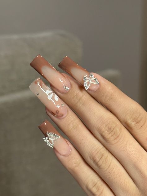 @ xnailsbyariana on instagram #brownnails #fallnails #butterflynails #blingnails #brownfrenchtip #flowernails #longnails #acrylicnails #acrylicnailssquare #squarenails brown nails, brown nail inspo, fall nails, fall nail inspo, butterfly nails, butterfly nail inspo, brown french tip nails, flower nails, flower nail inspo, long acrylic nails, square acrylic nails Brown Nails With Butterflies, Fall Nails Inspo Square, Tan Nails Acrylic Design, Brown Hoco Nails, Pretty Nails Brown, Different Brown Nails, Fall Tapered Square Nails, Brown Spring Nails, Cute Fall Gel Nails