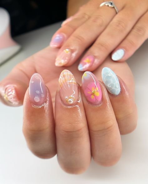 summer freestyle for maddie 🌺🫧🐚 i’m actually so in love with how this set turned out omg and it was so fun to make the water nail likeeee look how realistic?? love. #nails #nailart #summernails #summer #gelx #gel #gelnails #vbeautypure #apresgelx #après #vbp #nailinspo #nailinspiration #gelextensions #almondnails Glazed Nails Design, Nails Different Designs Each Finger, The Summer I Turned Pretty Nails, Water Nail Designs, Gel Nail Designs Natural Nails, Garden Nails Design, Nail Summer Ideas, Nails For Europe Trip, Fun Nails Summer