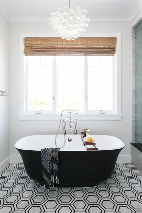 Master Bathroom | Black + White | Bubble Chandelier | Black Soaking Tub | #interiordesign #homedecor #coastal #beachhouse Over Tub Lighting Master Bath, Over Tub Chandelier, Chandelier Over Soaking Tub, Chandelier In Bathroom Farmhouse, Master Bath Chandelier Over Tub Bathroom, Tub Lighting Master Bath, Chandelier In Master Bath, Chandelier Over Bath, Master Bath Chandelier Over Tub Modern