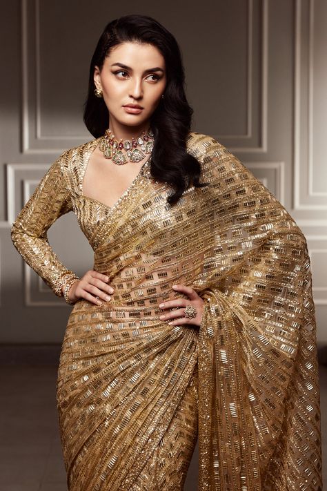 A divine metallic gold tulle #mymmsaree embellished with our signature sequins. Coupled with a metallic gold sweetheart neckline #mmblouse and juliet sleeves, weaving an artisanal couture for your ceremonial celebration Golden Saree For Reception Bride, Gold Saree Look, Golden Sequin Saree, Golden Saree Look, Metallic Saree, Golden Lehenga, Gold Saree, My First Story, Engagement Saree