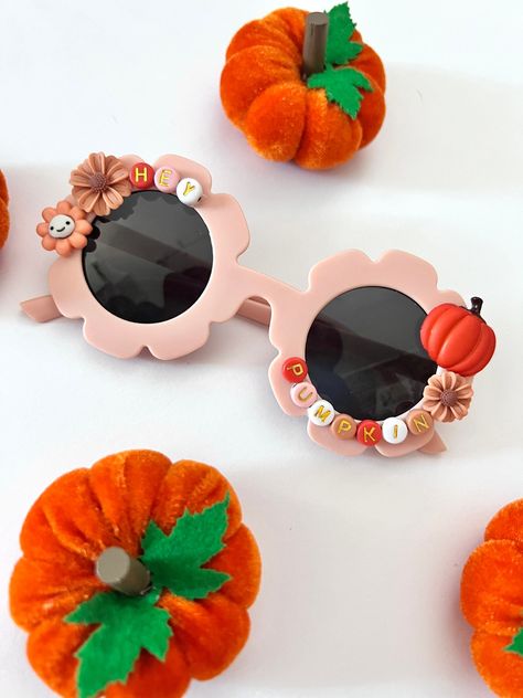 "Kids \"HEY PUMPKIN\" Sunglasses  *Available in 2 sizes: *Babies: 4 months-1.5 years  *Kids: 2 -12 years  * Anti-Glare * UV Protection (UVA & UVB) * Durable and shatterproof  * They open and close smoothly  ** Each item is made to order and will be ready to ship in 5-7 business days! If you need your order sooner. Please check out my \"RUSH ORDER OPTION\".  https://www.etsy.com/EyeCandyandFluff/listing/1286351273/rush-my-order-please *SHOP DISCLAIMER/WAIVER!  * Do NOT let your child put the sunglasses in their mouth as beads can become detached.    Always monitor and supervise while children are wearing these. The shop assumes no responsibility for sunglasses made. If you need to make a large order, contact me to discuss creating a custom listing and a discounted price! WE HAVE YOU COVERED Halloween Sunnies, Glowforge Gifts, Halloween Sunglasses, Diy Sunglasses, Hey Pumpkin, Novelty Glasses, Beaded Sunglasses, Personalized Sunglasses, Flower Sunglasses