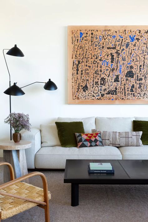 When simplifying a small living room you want to reduce the visual clutter, so along with choosing larger pieces and less of you, take the same approach to your living room wall decor. Stick with large-scale prints that really fill the wall, rather than a gallery of smaller prints that are going to feel too fussy in a smaller room. (Image credit: Julia King) Contemporary Eclectic Living Room, English Tudor Homes, Calming Decor, Visual Clutter, High End Residential, Modernist House, Beverly Hills Houses, Work Studio, Spanish Style Home