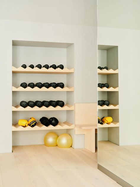 workout equipment in Hagius Berlin gym Home Gym Built In Storage, Hidden Gym Equipment, Hidden Home Gym, Gym Cubbies, Boutique Gym Design Fitness Studio, Pilates Storage, Home Gym Set Up Ideas, Half Garage Gym Ideas, Half Garage Gym