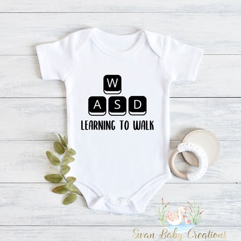 Introducing our adorable collection of baby bodysuits and toddler shirts! These charming and comfortable garments are perfect for your little ones to rock in style and comfort. Each piece is carefully crafted with love and attention to detail to ensure a delightful experience for both parent and child. 🌟 Key Features: 💜Superior softness: Made from premium, high-quality fabrics, our baby bodysuits and toddler shirts are incredibly soft and gentle on delicate skin. Your little bundle of joy will Video Game Baby Shower Ideas, Gamer Nursery, Nerdy Onesies, Cute Baby Outfits For Boys, Nerdy Baby Announcement, Gamer Baby Announcement, Gamer Pregnancy Announcement, Nerdy Baby Clothes, Baby Clothes Funny