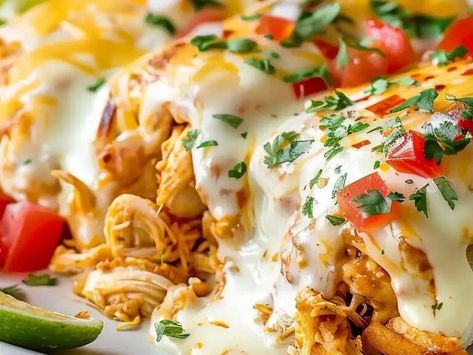 Smothered Baked Chicken Burritos: A Comforting, Cheesy Delight for Busy Nights - NewsBreak Smothered Baked Chicken Burritos, Smothered Chicken Burritos, Burrito Bake, Cilantro Salsa, Enchilada Pasta, Indian Pudding, Green Chili Sauce, Chicken Croquettes, Onion Dip Recipe