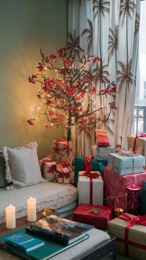 Floral branch Christmas tree with red flowers, fairy lights, and gifts in a cozy living room Decorating For Christmas Without A Tree, Kids Room Christmas Tree, Tree Branch Christmas Tree, Non Traditional Christmas Tree, Studio Hacks, Alternative Christmas Tree Ideas, Tree With Red Flowers, Christmas Tree Alternative, Christmas Tree Alternatives