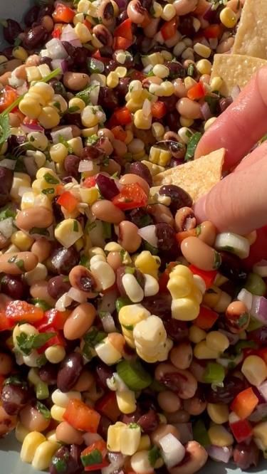 This easy black bean corn salsa recipe is similar to cowboy caviar, featuring fresh veggies, onion, herbs, beans, and corn. Make a big batch of this black bean dip to serve as an easy appetizer or side dish for any party, holiday, or celebration. Sweet, savory, and tangy, this fresh and healthy black bean and corn dip is made for scooping! Just know that once you start, you might not be able to stop. Black Bean Corn Dip Recipe, Black Bean Dip Easy, Corn And Black Bean Salad Recipe, Vegetarian Appetizers For Party Easy, Black Bean And Corn Salads, Black Beans Dip, Corn Black Bean Dip, Corn And Black Bean Dip, Recipes Using Black Beans