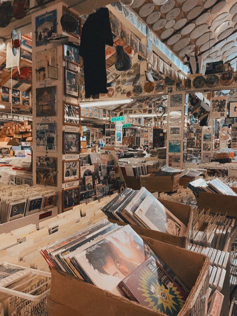 a photo of a record store with photos, posters, and shirts covering all the walls. it has a slightly brown tinted filter. Rochester New York Aesthetic, Rochester Ny Aesthetic, Guitar Store Aesthetic, Grey Aesthetics, Record Stores, Guitar Store, Rochester New York, New York Aesthetic, Rochester Ny