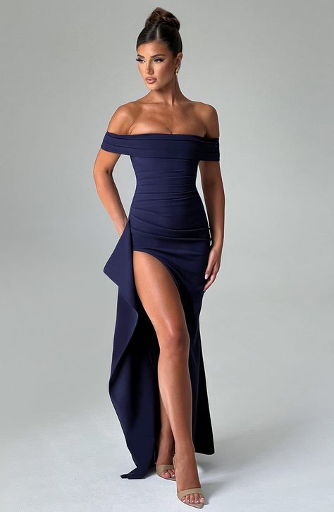 Simplicity at its most elegant in our Joyce maxi dress, cut from our luxury stretch crepe fabric. With a vintage feel, this dress sweeps over the shoulders with a pleated bardot neckline, while the bodice snatches your waist and hugs your curves to perfection with another pleat detail. We love the thigh high skirt split and elegant drape detail to the side.     Colour: Navy.  Stretch crepe fabric.  Moulds to your body.  Pleated bardot neckline.  Off the shoulder.  Draped detail thigh high split. Blue Navy Bridesmaid Dress, Vintage Formal Outfit, Navy Dress Wedding Guest, Wedding Guest Inspo Outfit, Year 12 Formal Dresses, Singing Outfits, Navy Formal Dresses, Summer Evening Wear, Off The Shoulder Prom Dresses