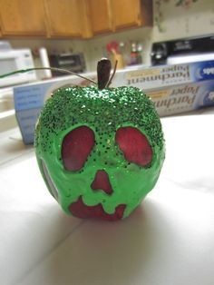 Snow White Poisoned Apple -fake apple,  at Michaels  -green fabric paint, at Michaels (definitely could have gone with the smaller, cheaper bottle)  -green glitter, not sure of the cost ’cause I found this for freeeeee  -twine, also already had this  -paintbrush  (not pictured)  -felt pen  -Elmer’s glue (probably don’t need this, see step 4)  -paper towels  -small dish  -tid bit of water Snow White Poison Apple, Diy Snow, Snow White Birthday, Tema Disney, Snow White Party, Poison Apple, Poison Apples, Snow White And The Seven Dwarfs, Disney Crafts