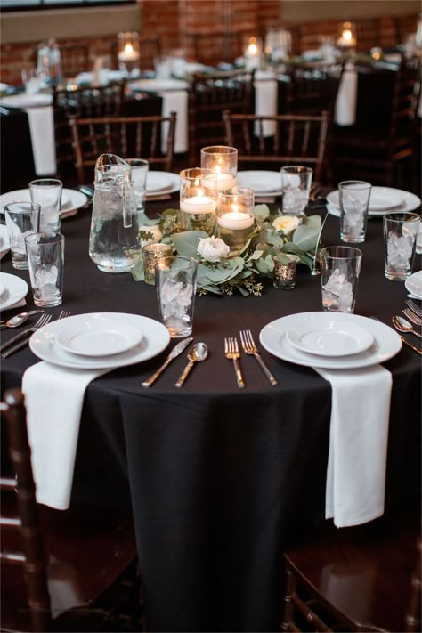 An elegant centerpiece to add to your beautiful space! Black And White Tablecloth Wedding, Black Tablecloth Round Table Wedding, Round Table Decor For Party, Black Tie Round Table Decor, Round Table Black Tablecloth, Candle Centerpieces Wedding Black Table Cloth, Black Tablecloth Wedding With Candles, Centerpieces For Black Tablecloth, Black Linen Table Decor