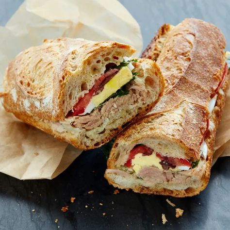 When you think about it, "Pan Bagnat" is just a fancy way of saying "the best of all possible summer sandwiches." Unlike the typical tuna on wheat, this Provençal classic only gets better as sits, making it just the thing for picnics, backyard suppers, and last-minute road trips. And its briny, garlicky flavors beat plain old mayo any day. Anchovy Recipes, Seafood Sandwiches, Canned Tuna Recipes, Parsley Recipes, Picnic Sandwiches, Summer Sandwiches, 100 Calorie, Tuna Recipes, Best Sandwich