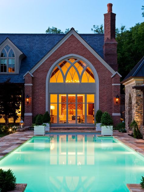 A beautifully lit, contemporary outdoor pool contrasts nicely with a classic, red brick house. Jamie Beckwith, Outdoor Space Ideas, Contemporary Pool, Red Brick Exteriors, Pool Areas, Red Brick House, Craftsman Style Home, Traditional Exterior, Contemporary Outdoor