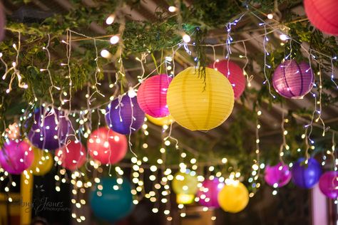 Village hall wedding - paper lanterns - colourful wedding decorations - fairy lights. What a fabulous wa to light up your wedding!  www.amyjamesphotography.co.uk Wedding Lantern Decor Fairy Lights, Paper Lanterns Outdoor Party, Party Lanterns Decor, Decorating A Hall For A Party, Colorful Prom Theme, Festival Garden Party Decoration, Lanterns Birthday Decor, Coloured Lanterns Wedding, Indoor Festival Party Decorations