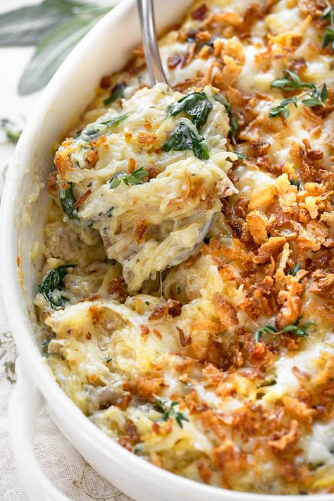 Brimming with fall flavors, this spaghetti squash casserole is prepared with a creamy Gruyere sauce and topped with crispy fried onions! | thecozyapron.com #spaghettisquashcasserole #spaghettisquashcasserolerecipes #spaghettisquashcasserolehealthy Thanksgiving Spaghetti Squash Recipes, Spaghetti Squash With Sausage And Spinach, Fall Squash Casserole, Spaghetti Squash Thanksgiving, Thanksgiving Spaghetti Squash, French Onion Spaghetti Squash, Spaghetti Squash Carbonara Recipes, Veggie Casserole Recipes Thanksgiving, Healthy Fall Casserole Recipes