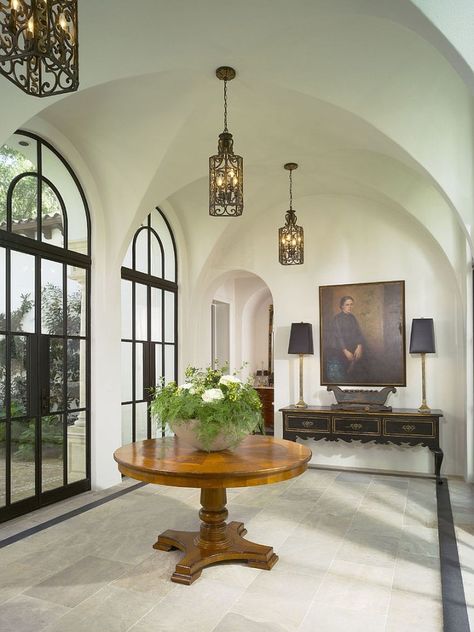 Style of the doors and lovely lighting creates a cool Mediterranean vibe [Design: Summerour Architects] Mediterranean Entryway, Steel Doors And Windows, Christmas House Lights, Crown Crystal, Entry Design, Farmhouse Side Table, Foyer Entryway, Casas Coloniales, Entry Way Design