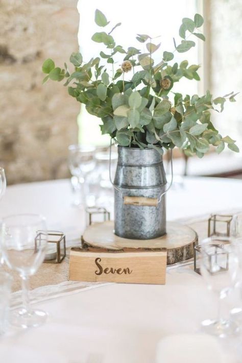 Rustic milk churn centrepiece with eucalyptus on a wood slice with brass tea light holders and a wooden table number. All on top of a hessian and lace table runner. Wedding styling at Healey Barn in Northumberland. Small Wedding Cakes Rustic, Eucalyptus Table Setting, Burlap Table Settings, Eucalyptus Wedding Centerpiece, Rustic Round Table, Wedding Cakes Rustic, Burlap Wedding Table, Rustic Wedding Table Setting, Lace Table Runner Wedding