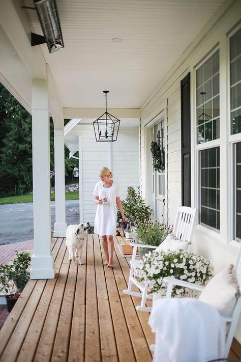 A favourite spot at our home is the front porch. It’s a beautiful place to sit in the morning and listen to the birds sing. In the evening,  the sun sets just right above and below the trees,  so Steve and I love to unwind from the day and watch the kids play up and down our long driveway. When… Long Verandah Ideas, Cottage Home Front Porch, Back Porch Inspiration Outdoor Living, Front Porch Ideas Large, Small Wood Front Porch Ideas, Country Style Outdoor Area, Styling A Long Front Porch, Front Porch Bench Styling, Front Porch White Rocking Chairs