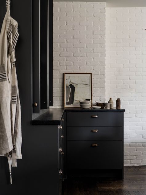 Contemporary Colonial Interiors, Modernist Kitchen, Black Cabinetry, Colonial Interiors, Country Colonial, Dark Bathroom, Man Chair, Cabinet Inspiration, Black And White Contrast