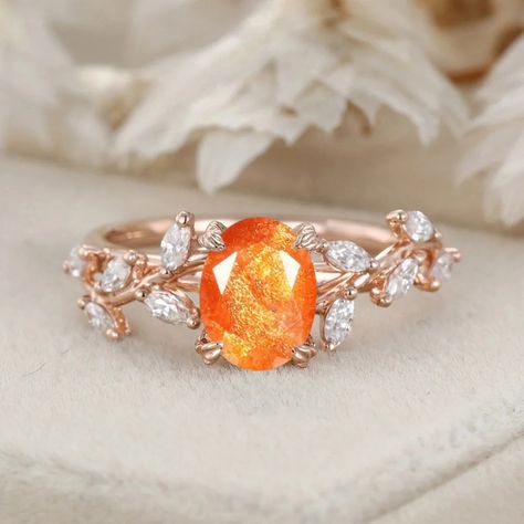 Our Handcrafted Oval Cut Sunstone Engagement Ring features a Nature-Inspired Branch Cluster in Solid Gold. The oval-cut sunstone and the cluster design create a ring that is both artistic and romantically inspired by the beauty of the natural world." Sunstone Ring Engagement, Orange Engagement Ring, Sunstone Engagement Ring, Sunstone Ring, Cluster Design, Cute Engagement Rings, Couple Wedding Rings, Colored Engagement Rings, Moonstone Engagement Ring