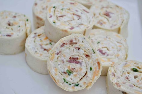 The ultimate make-ahead party appetizer, Chicken Bacon Ranch Pinwheels are super easy to make and such a crowd pleaser. Rotisserie chicken, cream cheese, bacon, cheddar, and ranch seasoning all rolled into a flatbread or tortilla. #pinwheelappetzier #superbowlpartyfood Blt Roll Ups, Ranch Pinwheels, Chicken Pinwheels, Tortilla Rolls, Bacon Chicken, Roll Ups Tortilla, Green Chiles, Black Olives, Tortilla Wraps