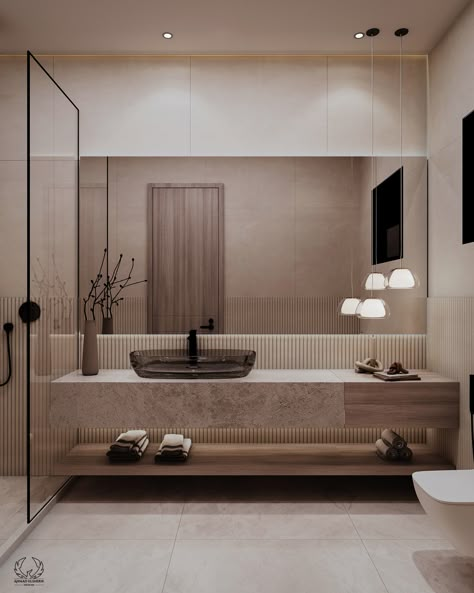 The floating stone vanity becomes the focal point, complemented by an elegant, clear glass sink that gives a touch of contemporary design. Warm wood tones and subtle textures strike a perfect balance, while minimalist pendant lighting and streamlined fixtures enhance the overall elegance. The space is neatly put together, providing both practicality and style.
#bathroom #bathroomRedesign #homeDecor #contemporaryBathroom Modern Bathroom With Floating Vanity, Toilet Wood Design, Elegant Bathroom Design Modern, Floating Sink Bathroom, Bathroom Minimalist Design, Modern Minimalist Bathroom Design, Warm Bathroom Ideas, 2 Sink Vanity, Bathroom Floating Vanity